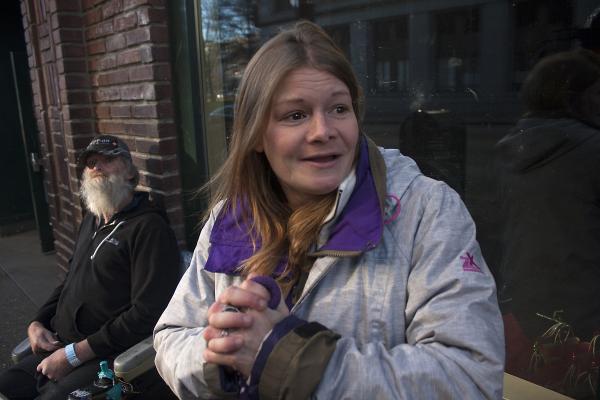 Carrie Clark tells her own story of homelessness, involving domestic violence, in front of DESC. Photo by Jon Williams