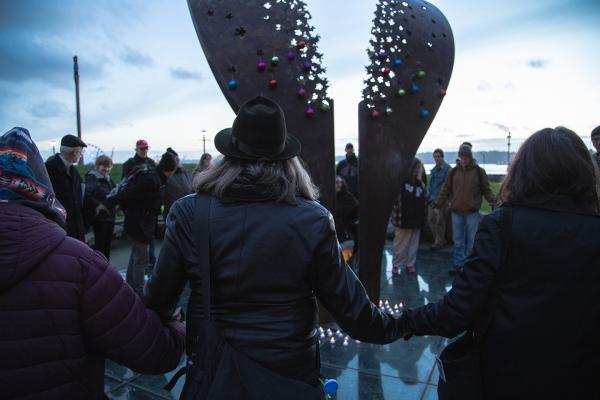 People gather around the Tree of Life in Victor Steinbrueck Park on Dec. 21 to remember those who died on the streets of King County in 2018. Photo by Matthew S. Browning