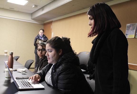 UW MEChA members Maria Martinez, Marilyn Sanchez Martinez and Gema Soto-Marquez look over a grant during one of the Monday meetings. Photo by Blake Peterson