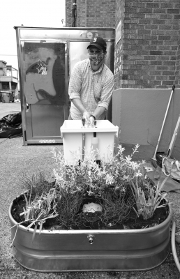 ROOTS Young Adult Shelter Executive Director Jerred Clouse tries out the new, environmentally friendly street sink that was installed in an alley next to the University District shelter.