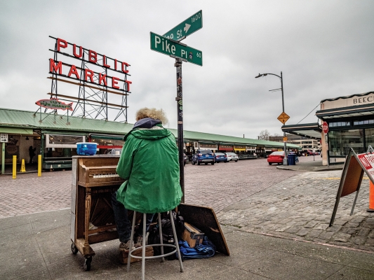 Our city’s street culture has been all but hollowed out. Johnny Hahn, who’s been busking Pike Place Market for three decades, continues to play, despite the empty streets.