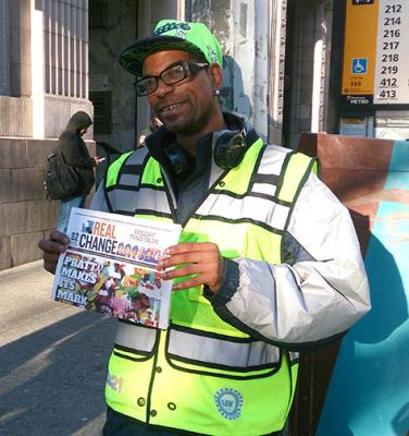 Zackary Tutwiler wearing the new high visibility vest while he sells papers at 2nd Ave. and Cherry St. The vests are provided by Granite Construction in partnership with the labor community. 