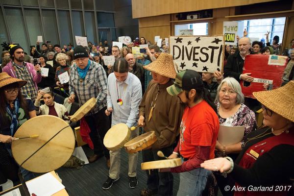 Protesters fill the Council Chambers at Seattle City Hall to celebrate the divestment of city funds from Wells Fargo on Feb. 7. Photo by Alex Garland