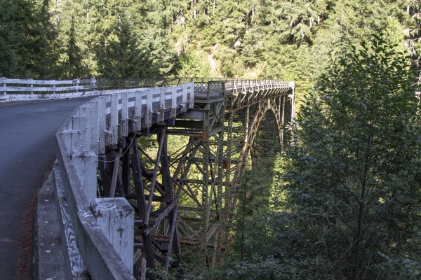 View of bridge over a canyon surrounded by trees and steep banks