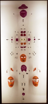 Wall display showing orange face masks and smaller components pinned to wall