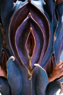 Vulva-shaped ceramic sculpture in purple tones