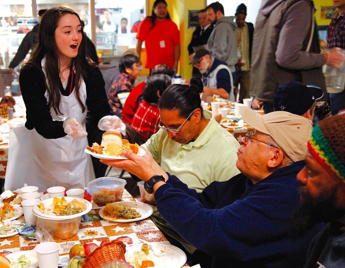 Sophia Pangallo, 17, serves meals to Thanksgiving diners at the Salvation Army in Seattle in 2015.  That year, the Salvation Army had a huge number of volunteers that equaled the amount of people coming in for a warm meal.