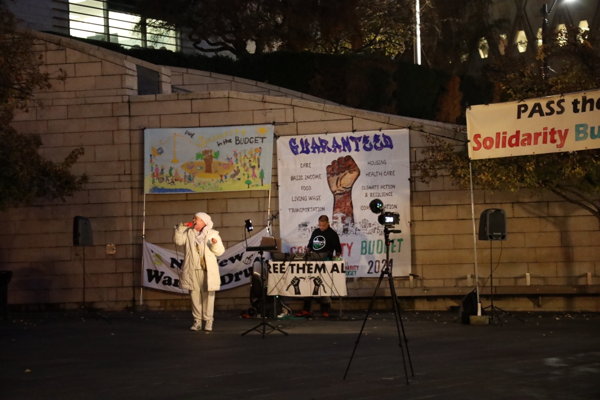 A performer sings at the Solidarity Budget rally, Nov. 11.