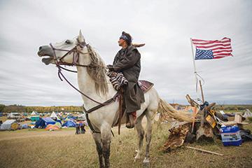 Frank Archambault rides security for the main camp, called Oceti Sakowin, on the Standing Rock reservation. Photo by Alex Garland