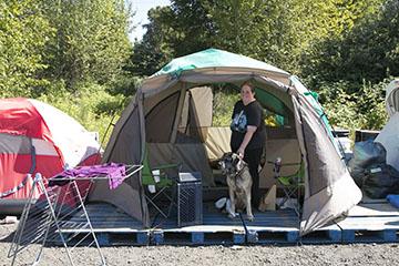 Alisa Christopher and her dog live in Camp Second Chance on Myers Way in West Seattle. Below, the camp’s Honey Buckets.