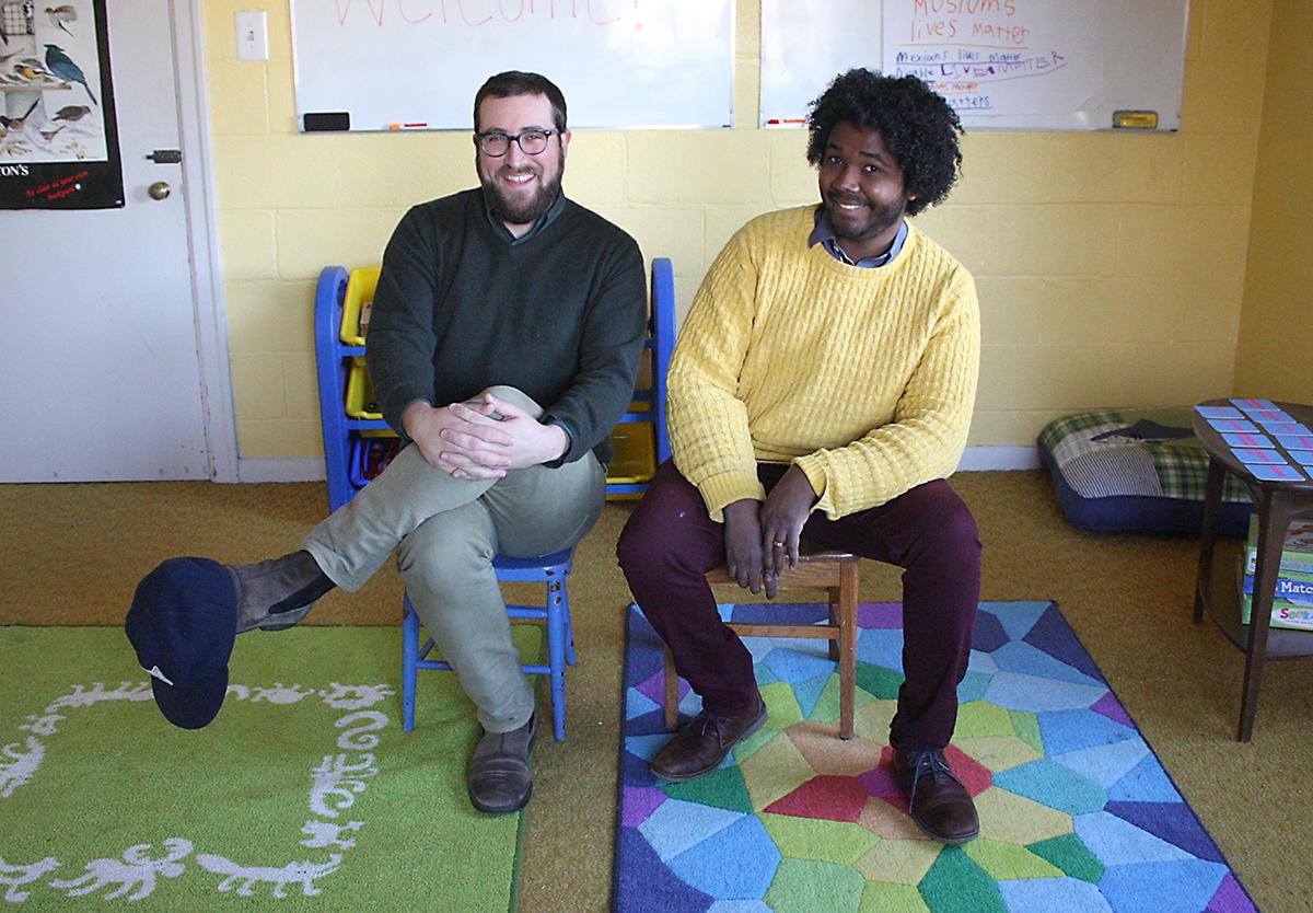 The founders of Columbia City Preschool of Arts and Culture, Benjamin Gore, left, and Jasen Frelot, sit in their preschool located in the Columbia City Church of Hope. Photo by Jon Williams, Real Change