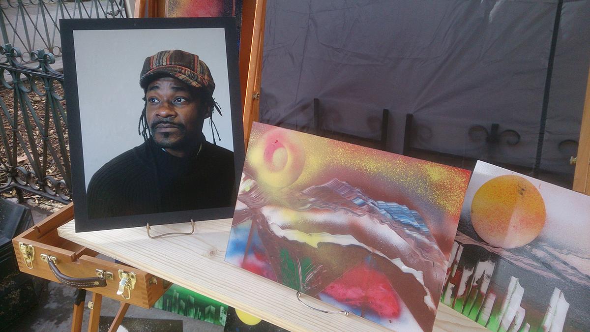 A portrait of Ewing sits next to some of his art at the memorial. Photo by Lisa Edge
