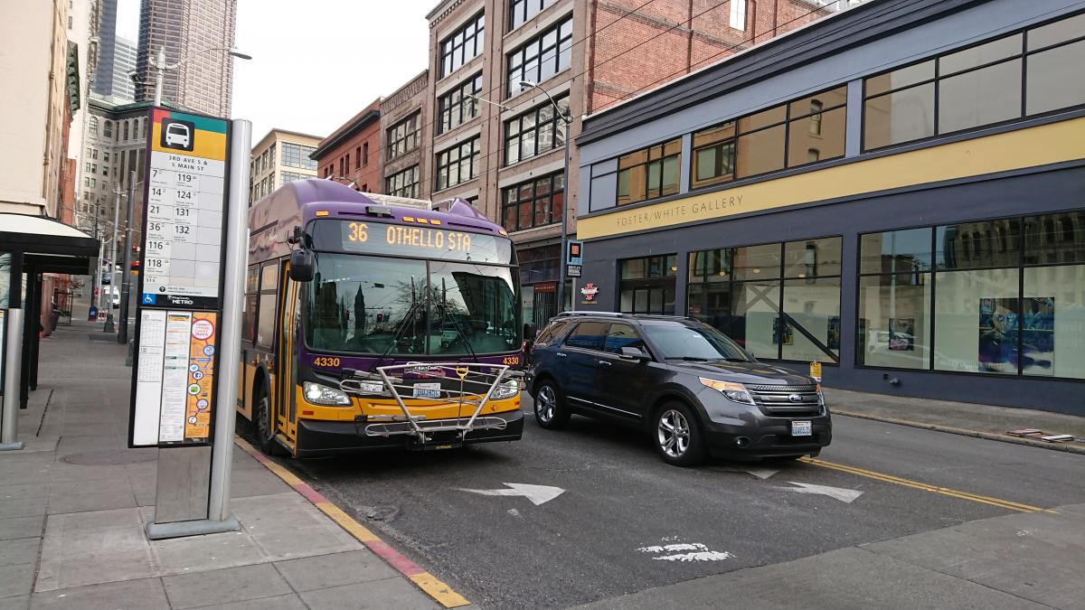A King County metro bus stops at a busy location in Pioneer Square. Photo by Lisa Edge