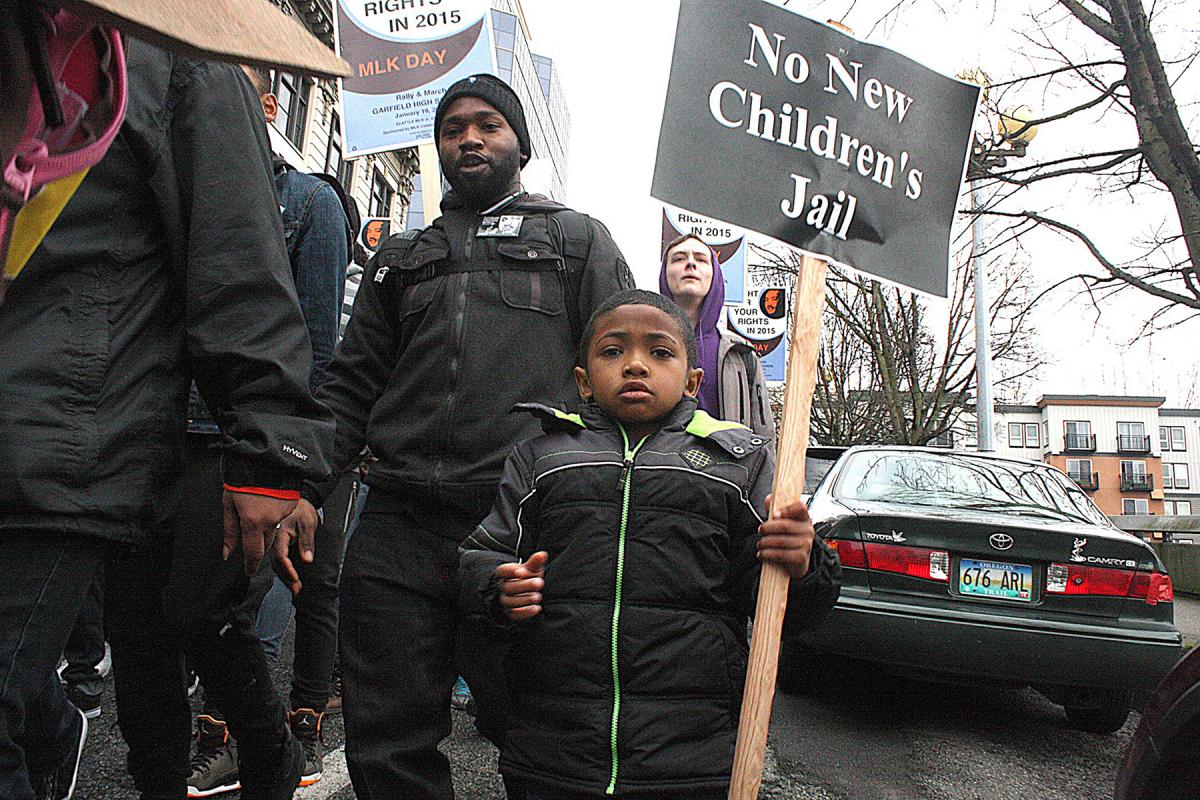 A young marcher carries a “No New Children’s Jail” sign at the 2015 MLK March in Seattle. Real Change file, 2015