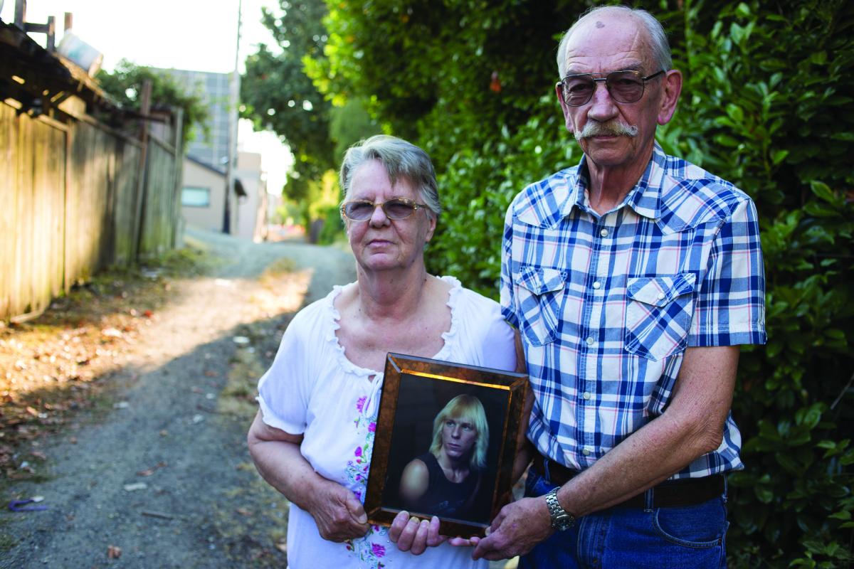 Priscilla Hill and Ed Pindar hold a photograph of Garry Hill on site where he was found unconscious in June 2014.