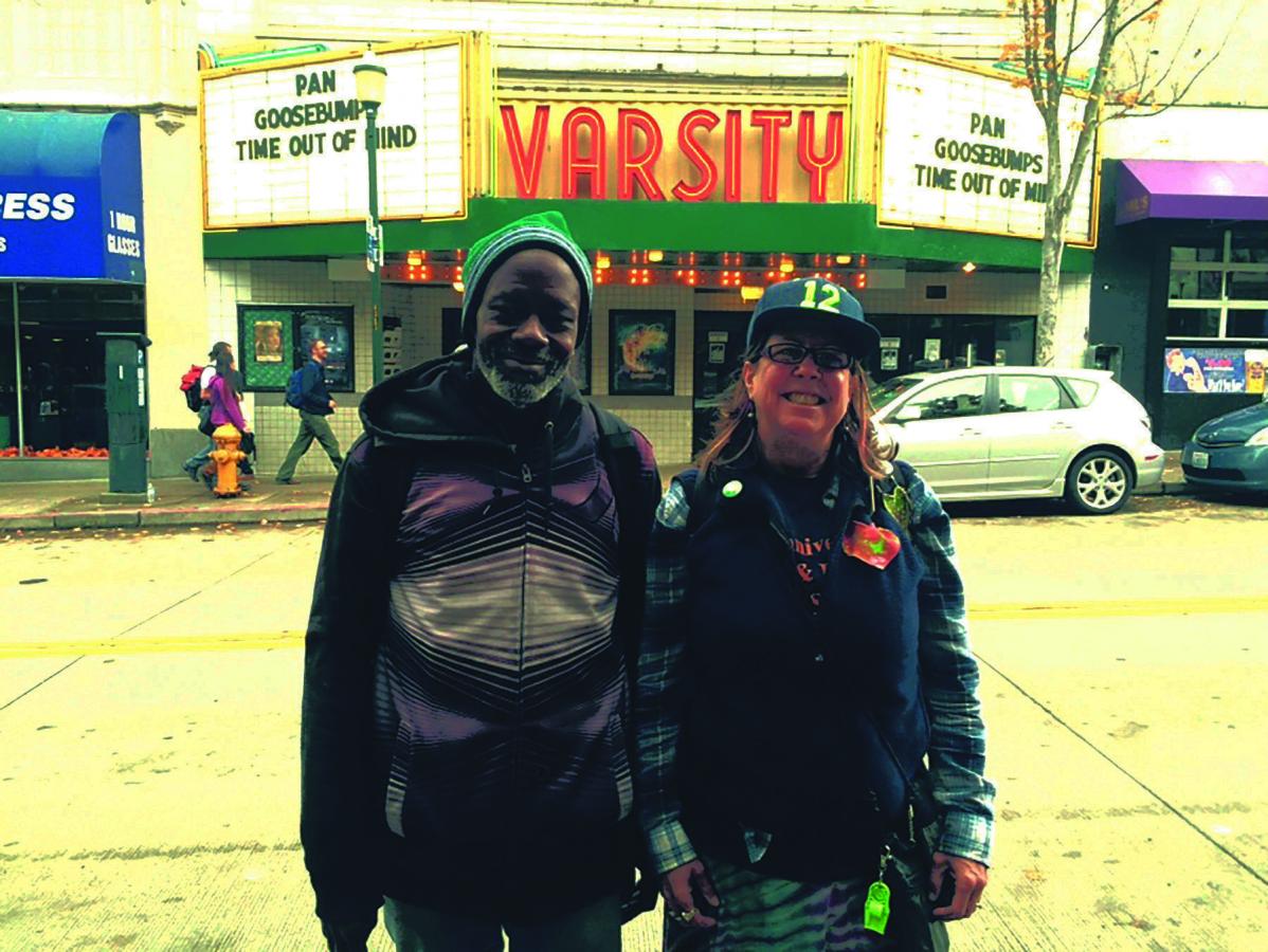 Tracey Williams and Susan Russell stand outside the Varsity Theatre in Seattle’s University District.