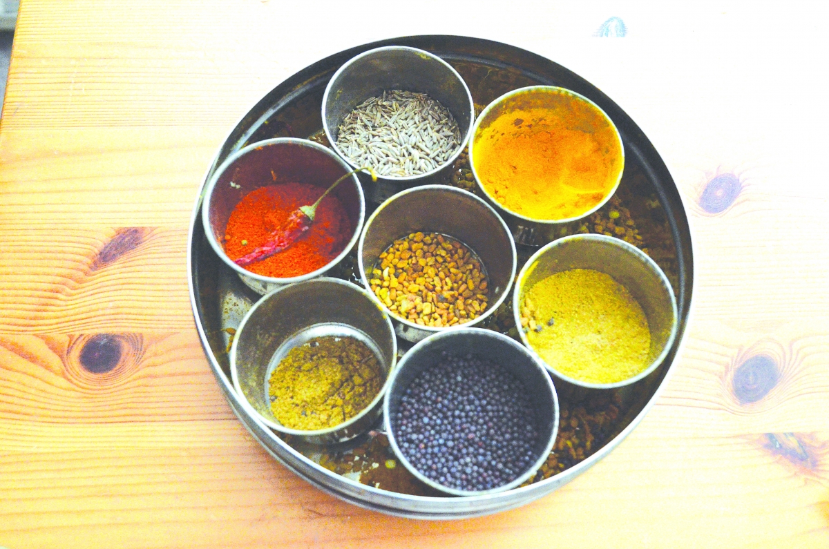 A traditional south Indian spice box which includes cumin (helps digestion), turmeric (anti-inflammatory and antioxidant), chili powder (to clear nasal congestion), coriander powder (lowers cholesterol, helps digestion), mustard seed (helps digestion and 