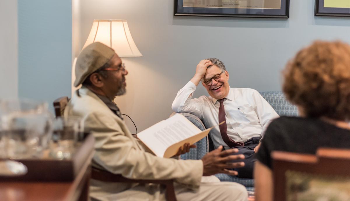 Vendor Ken Martin, left, meets with Sen. Al Franken during an interview for the Washington D.C. street paper, Street Sense. Photo by Benjamin Burgess