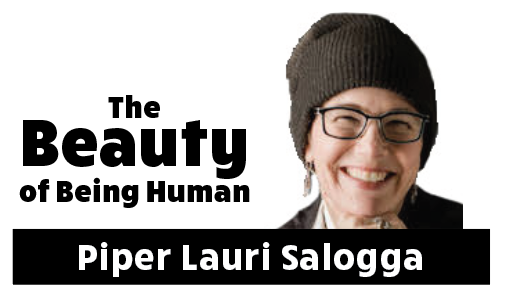 A headshot of the author, Piper Lauri Salogga, wearing a beanie and glasses and smiling into the camera.
