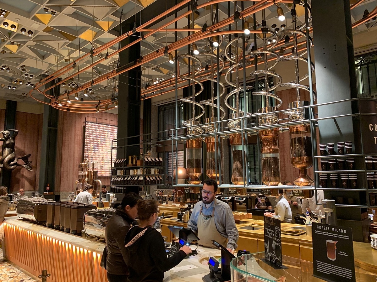 A view inside the world’s largest Starbucks in Milan, Italy. The city is a global hub of capitalism, just like Seattle. It also has the highest concentration of homelessness in Italy. Photo by Tim Harris 