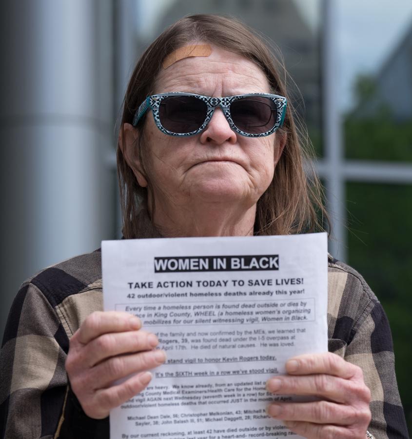 Diana Armstrong stands vigil outside the Seattle Municipal Court for the 42 homeless deaths that have occurred so far in 2018. Photo by Alex Bergstrom