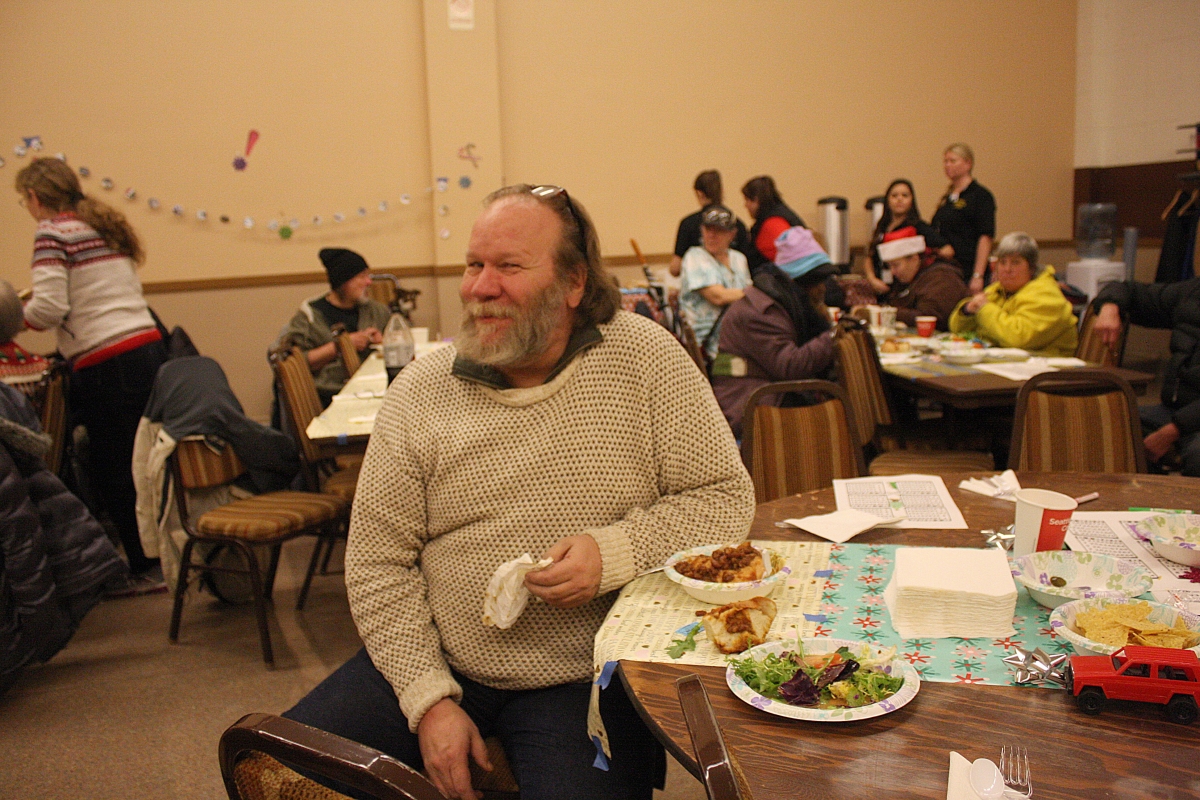 Long-time Real Change Vendor Neal Lampi celebrating the holidays with the Real Change community in 2015. After selling the paper since 2003, Lampi is preparing to move on and begin working on an oyster farm.