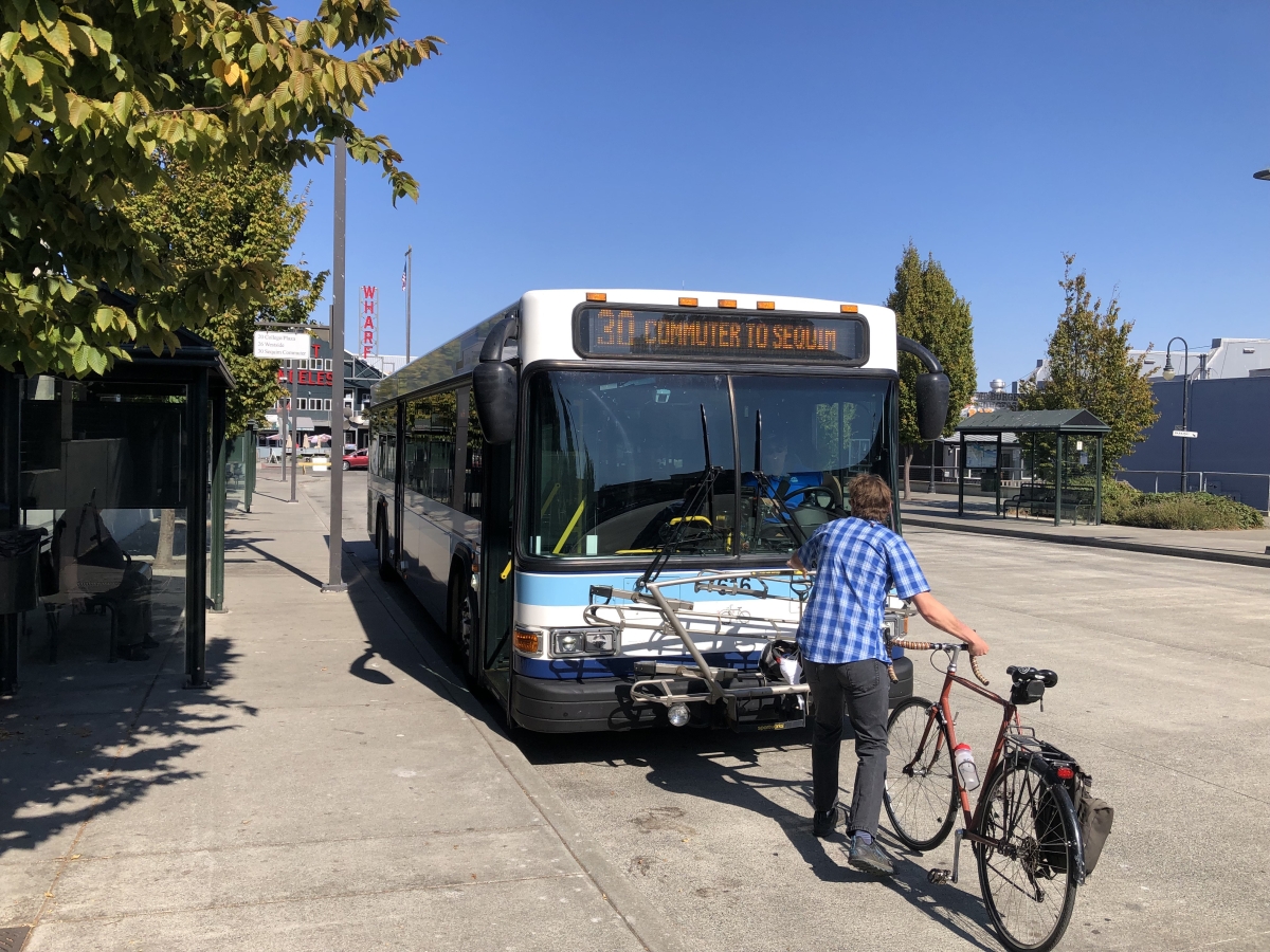 A man loading his bicycle on to the front rack of the bus in downtown Port Angeles