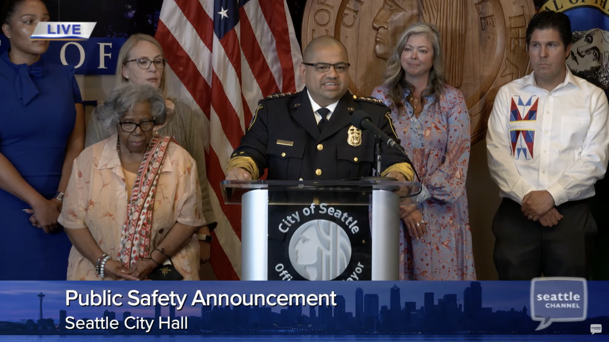 Screenshot of Chief Adrian Diaz standing at City of Seattle podium, flanked by four others
