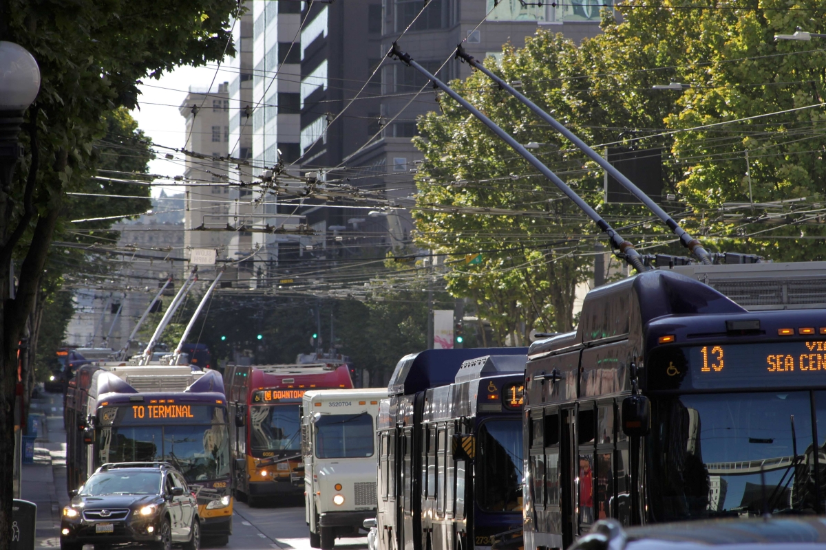 Photograph of city street with traffic consisting mostly of buses