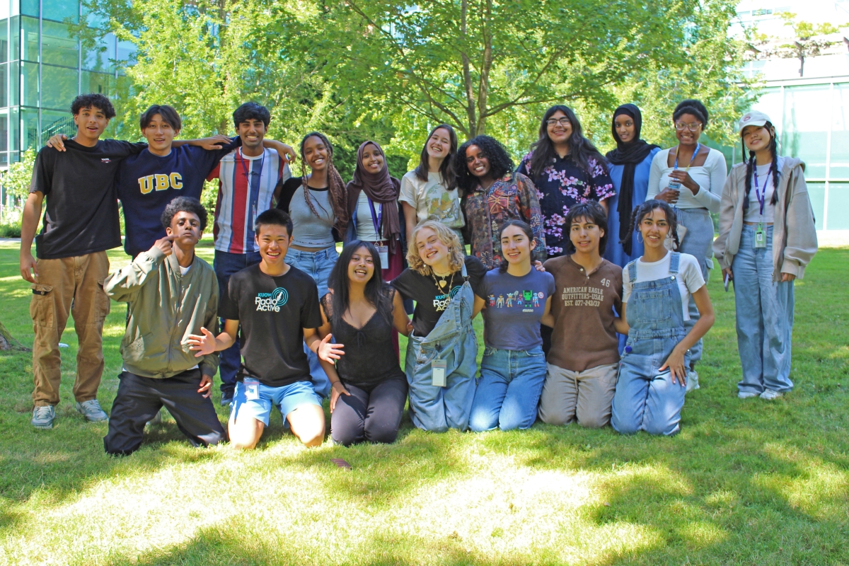 A group of young people pose and smile for the camera.