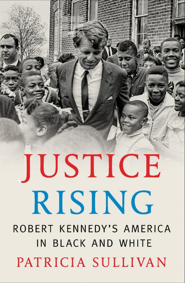 Robert F. Kennedy, surrounded by Black youths, in front of brick building. Title reads, 'Justice Rising: Robert Kennedy's America in Black and White' with author name, Patricia Sullivan