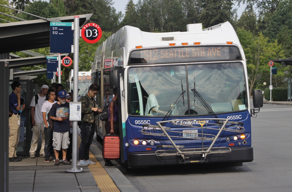 People gather to board a Sound Transit bus.