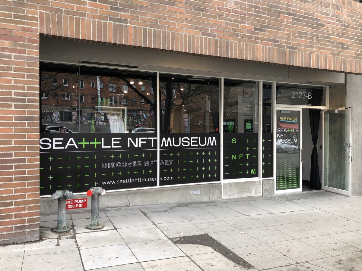 Glass-paned storefront with sign reading, "Seattle NFT Museum"