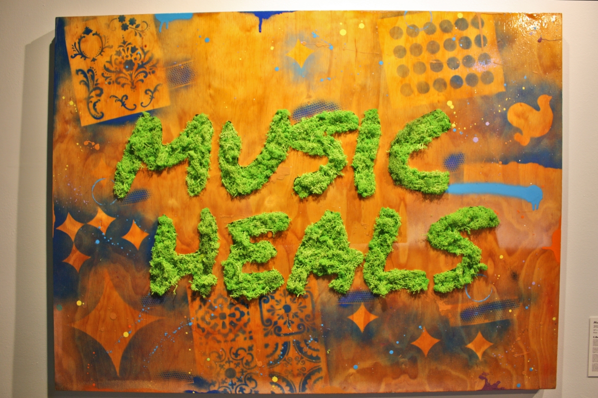  displayed as part of the “Positive Frequencies” exhibit at the Northwest African American Museum, “Music Heals” by C. Bennett has a strong statement, afirmed by the bold colors and use of spray paint. 