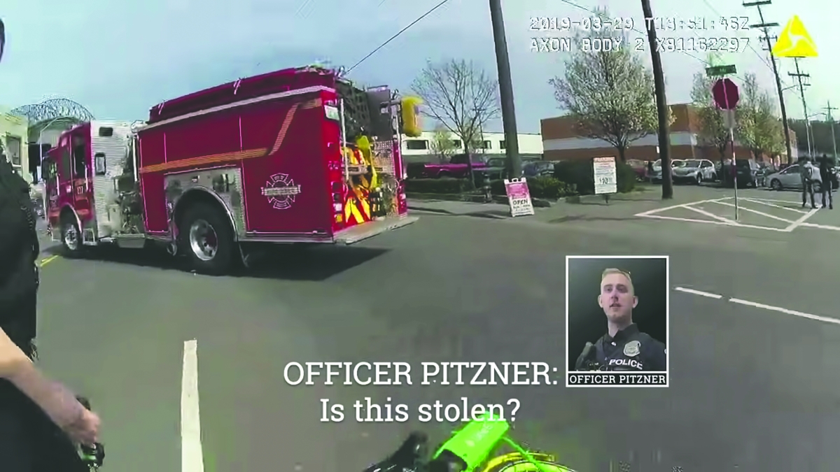 Screenshot from body cam footage with inset photo of young white police officer and text superimposed: "Officer Pitzner: Is this stolen?"