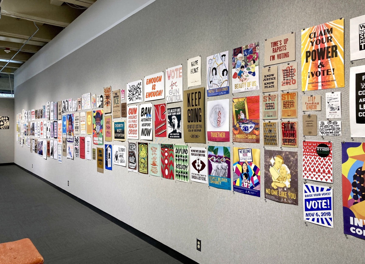 Dozens of protest signs and posters are displayed at the “Persist! Movement and Protest Art” exhibit at North Seattle College.