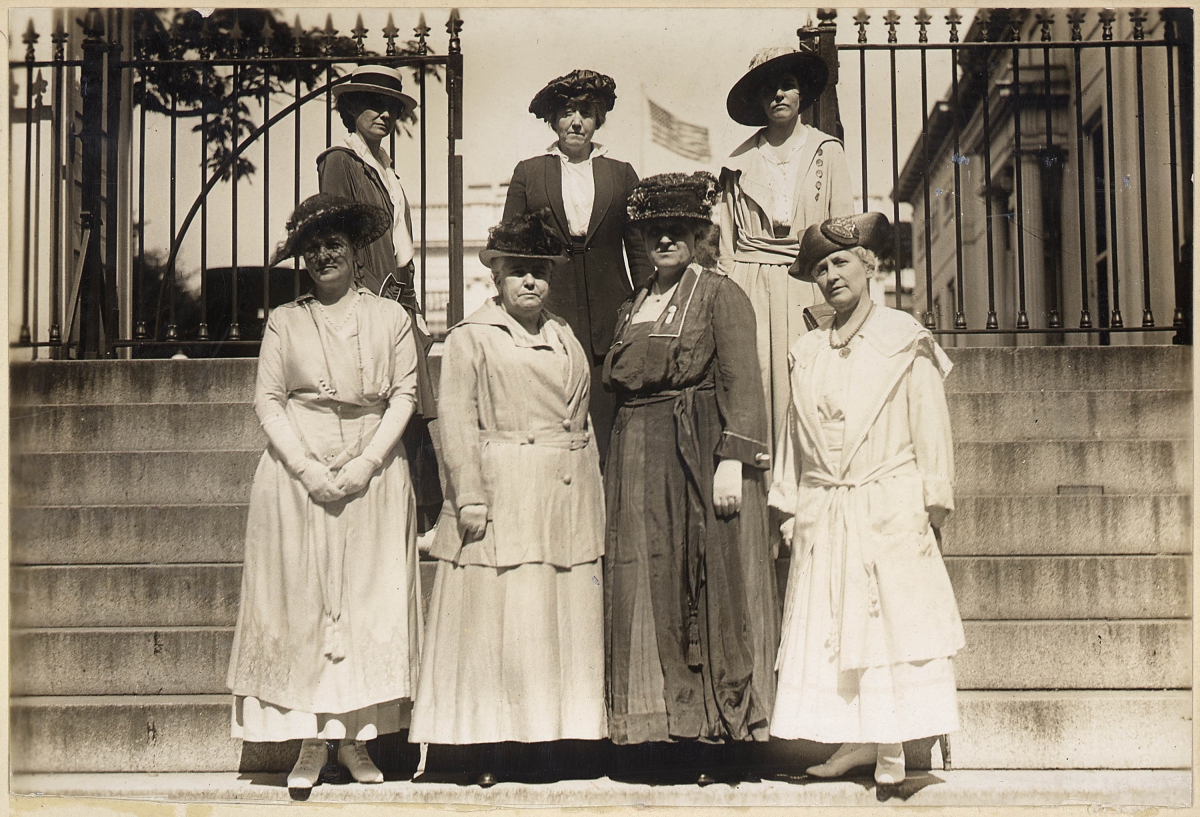 A photo of suffragettes posing on the steps of the White House.