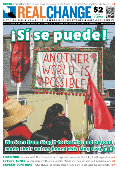 Photograph of people rallying under a banner and the heading, "Si, se puede!"