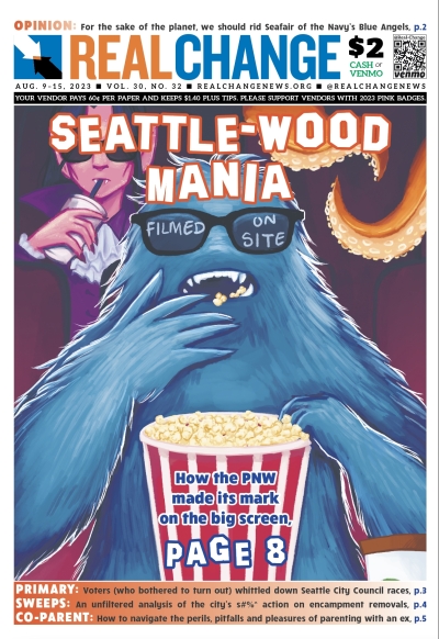 Drawing of blue Bigfoot-type monster wearing shades and eating popcorn under headline, "Seattle-Wood Mania"; a vampire character in shades visible in background, sipping from styrofoam cup