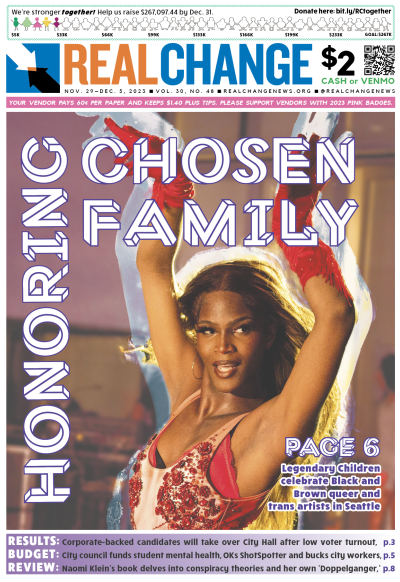 The cover of Real Change for Nov. 29; it features a performer in a red dress with red hair dancing, and the headline reads "Honoring chosen family."