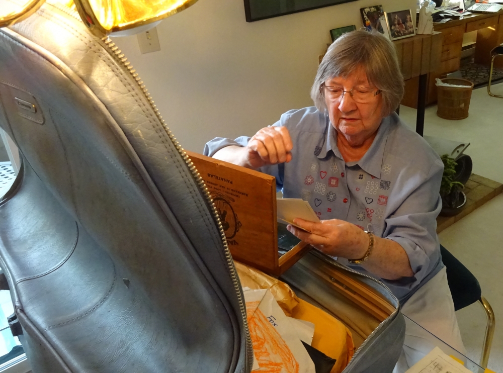 Frances Davis goes through the possessions of her son Donald Schultz. One of his friends stored the light blue suitcase and gave it to Davis after her son’s death. Photo by Lisa Edge