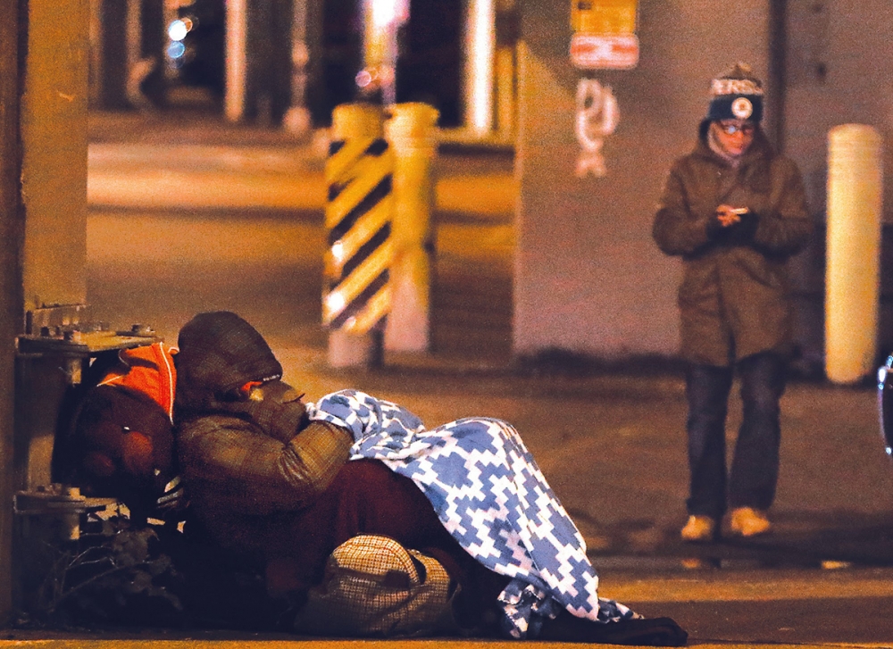 A volunteer walks the streets counting people who are homeless. One Night Count file photo.