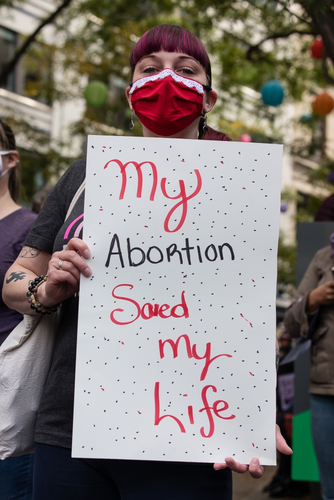 People in Seattle and Olympia held signs in defense of reproductive health and access to abortion as part of a national set of marches and rallies held Oct. 2. The U.S. Supreme Court is expected to hear a case in December 2021 that abortion rights advocat