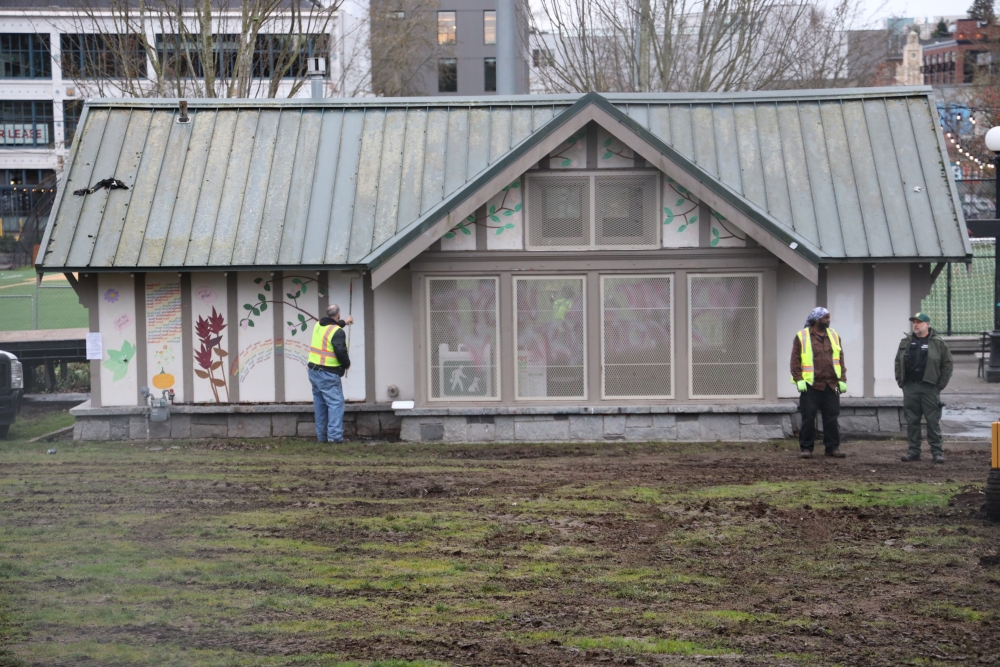 Parks employees and contractors paint over murals and graffiti adjacent to BLMG, Dec. 27, 2023.