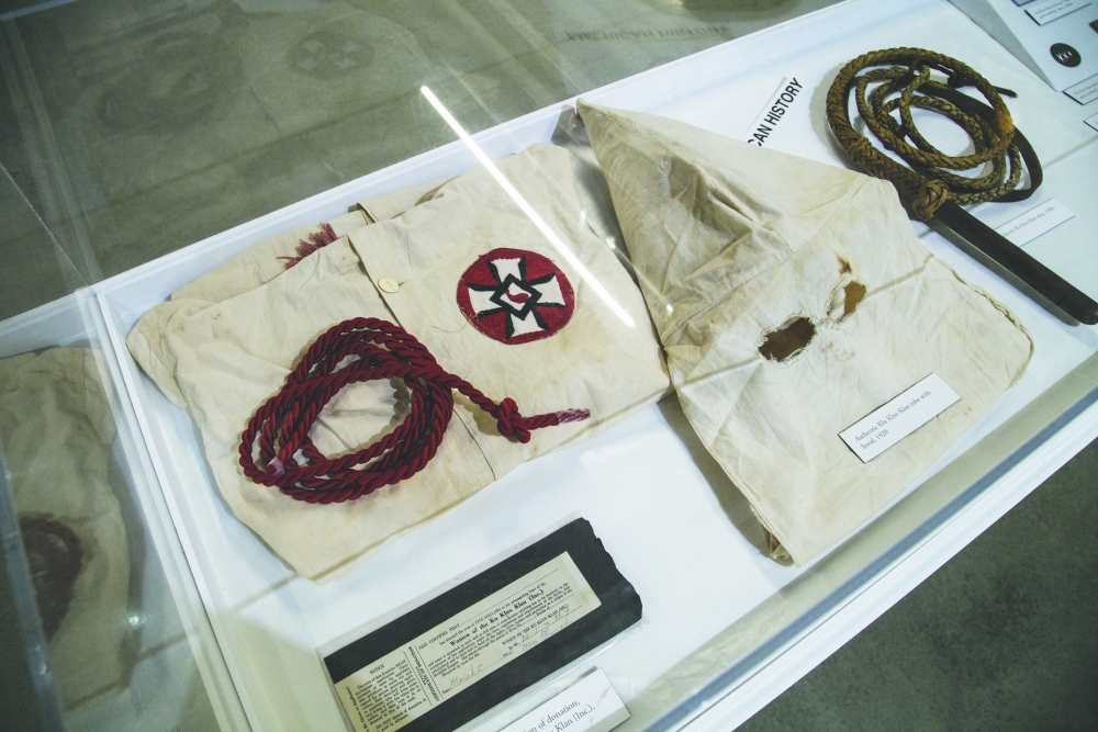 Exhibit portion showing Ku Klux Klan robe, hood, and rope