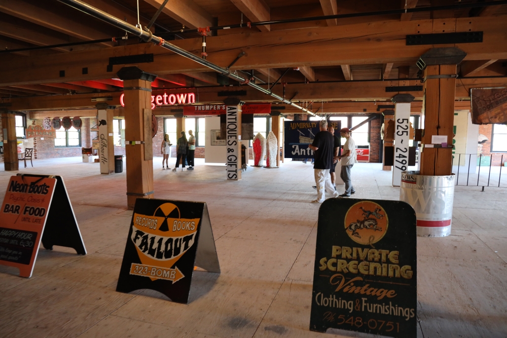 A floor of a Pioneer Square warehouse is filled with signs and memorabilia.