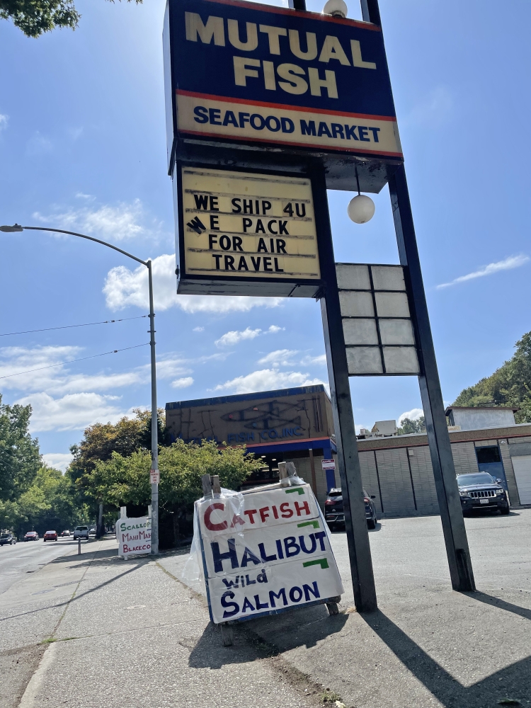 The sign for Mutual Fish Seafood Market on a sunny day in Seattle.