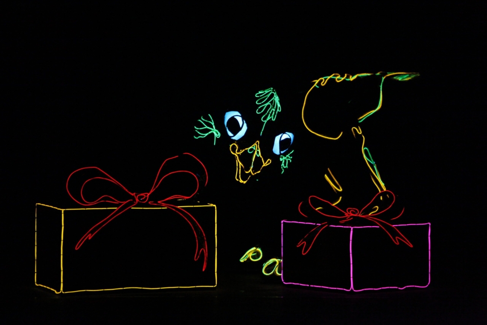 A bird and presents made out of neon lights
